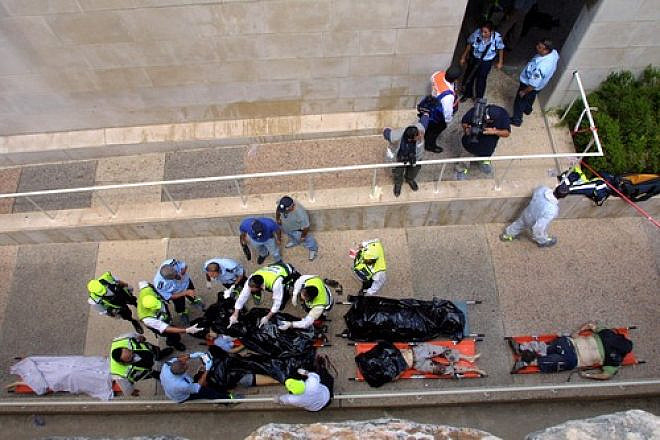 Bodies are taken away following an explosion at the cafeteria of Jerusalem's Hebrew University on July 31, 2002, during the years of the Second Intifada. Hamas took responsibility for the bombing, which killed seven people and wounded 70. Photo by Flash90.