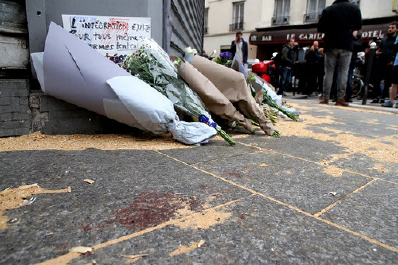 The Le Petit Cambodge restaurant—site of one of six coordinated Islamist terror attacks in Paris on Friday—with a makeshift memorial of flowers and blood staining the ground on the day after the attacks. Credit: Maya-Anaïs Yataghène via Wikimedia Commons.