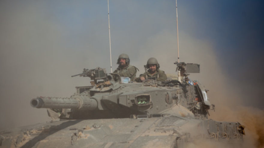An Israel Defense Forces tank crosses through a field near the border with Gaza in southern Israel on July 21, 2014, two weeks into “Operation Protective Edge.” Photo by Yonatan Sindel/Flash90.