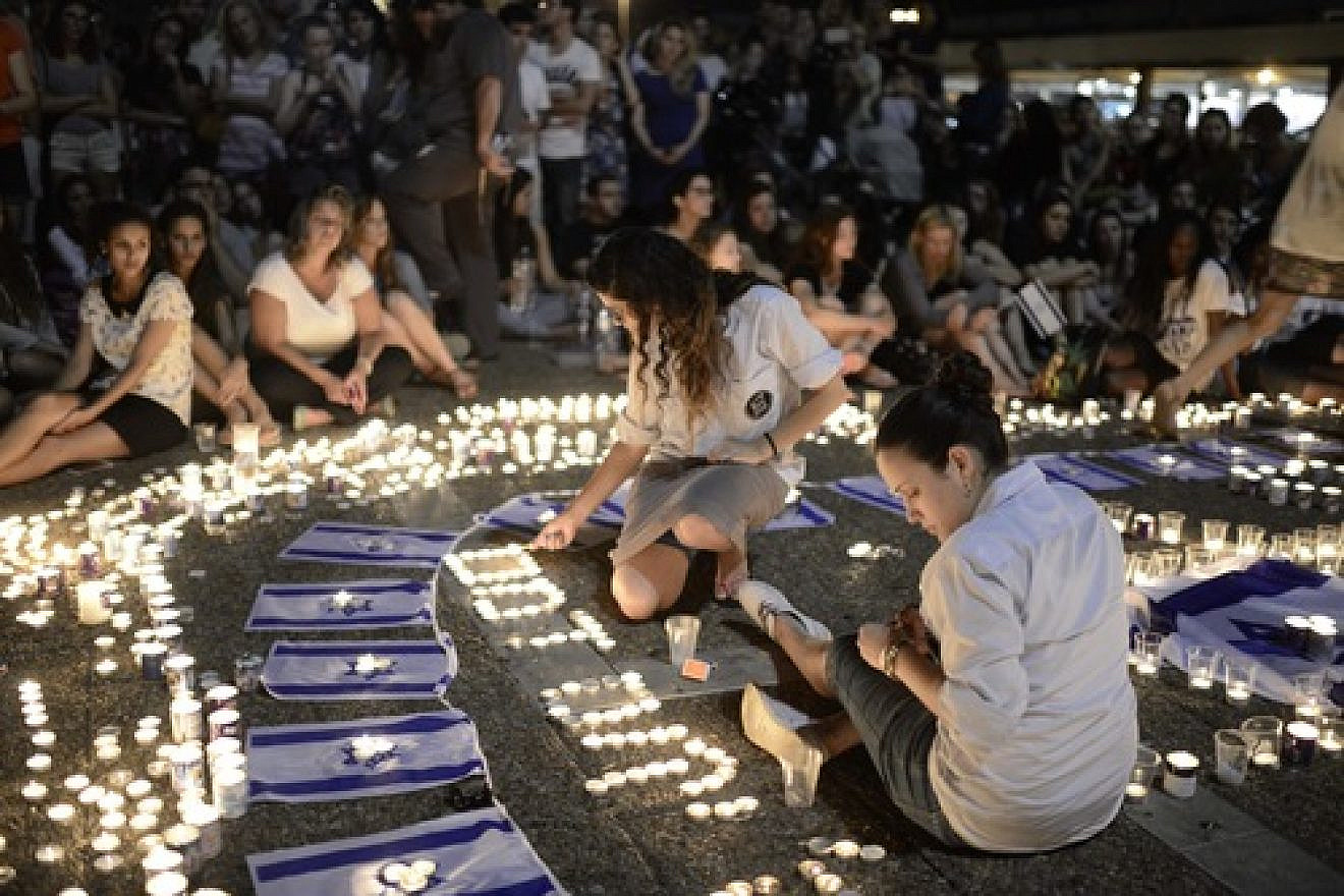 Click photo to download. Caption: Israelis light candles in Tel Aviv's Rabin Square on Monday as they mourn the news of the death of three abducted Jewish teenagers. Israeli forces found the bodies of the three missing teenagers on Monday after a nearly three-week-long search. Credit: Tomer Neuberg/Flash90.