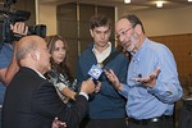 Click photo to download. Caption: Nobel laureate Alvin Roth, right, speaks with ABC reporter David Louie, left, after a press conference on his prize. Credit: Linda A. Cicero/Stanford News Service.
