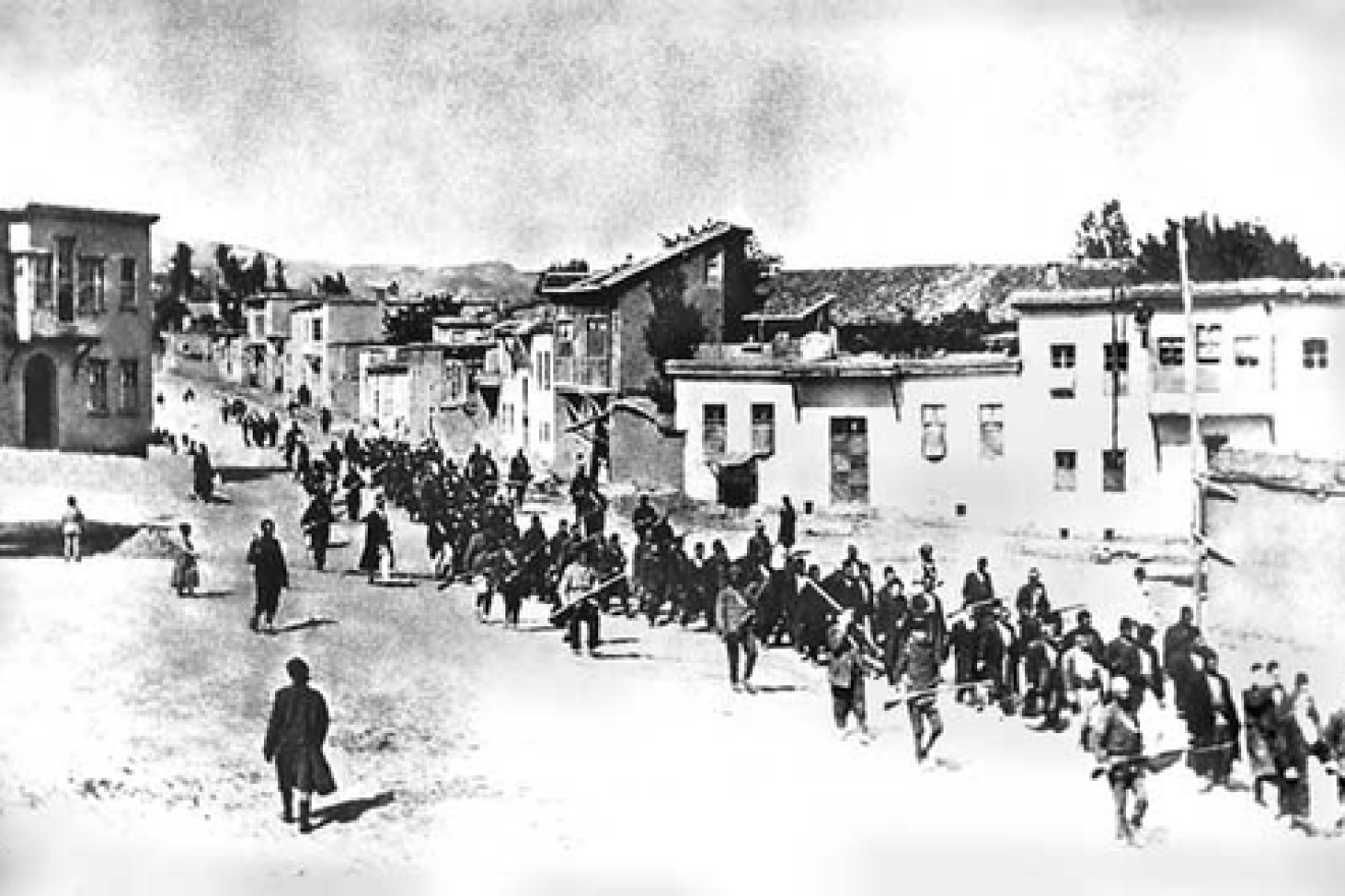 Armenians are marched to a nearby prison in Mezireh by armed Turkish soldiers in Kharpert, Armenia, in April 1915. Credit: Project SAVE via Wikimedia Commons.