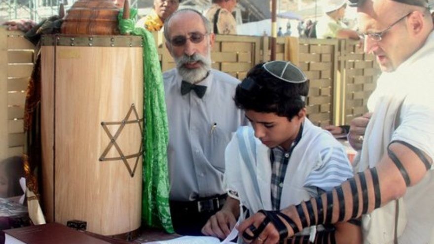 A bar mitzvah at the Western Wall. Mass exoduses from Jewish institutions after the age of bar or bat mitzvah point to a disturbing issue—that far too many decide that their Jewish learning is done, complete, at least from the perspective of formal education, writes Simon Klarfeld. Credit: Peter van der Sluijs via Wikimedia Commons.