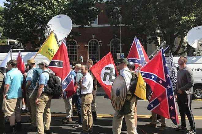 White-supremacist protesters carry Nazi and Confederate flags in Charlottesville, Va., on Aug. 12, 2017. Credit: Anthony Crider via Wikimedia Commons.