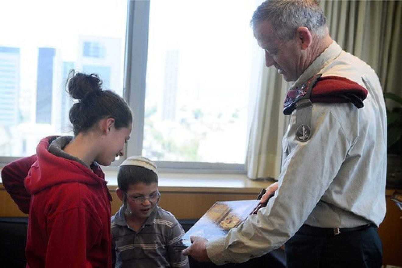 Former IDF Chief of Staff Lt. Benny Gantz meets with two surviving children of the Fogel family, whose parents and three siblings were murdered by Palestinians in the March 2011 Itamar massacre. Credit: Israel Defense Forces.