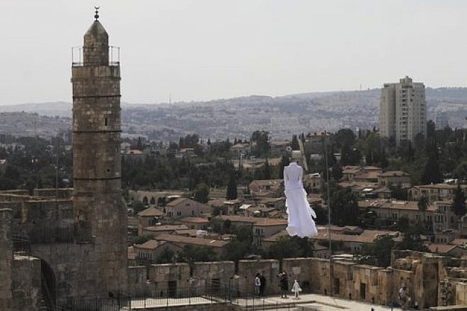 In 2015, a white bridal dress floats in the air near the Tower of David as part of the 2nd Jerusalem Biennale’s installation called “Betrothal.” Credit: Ricky Rachman.