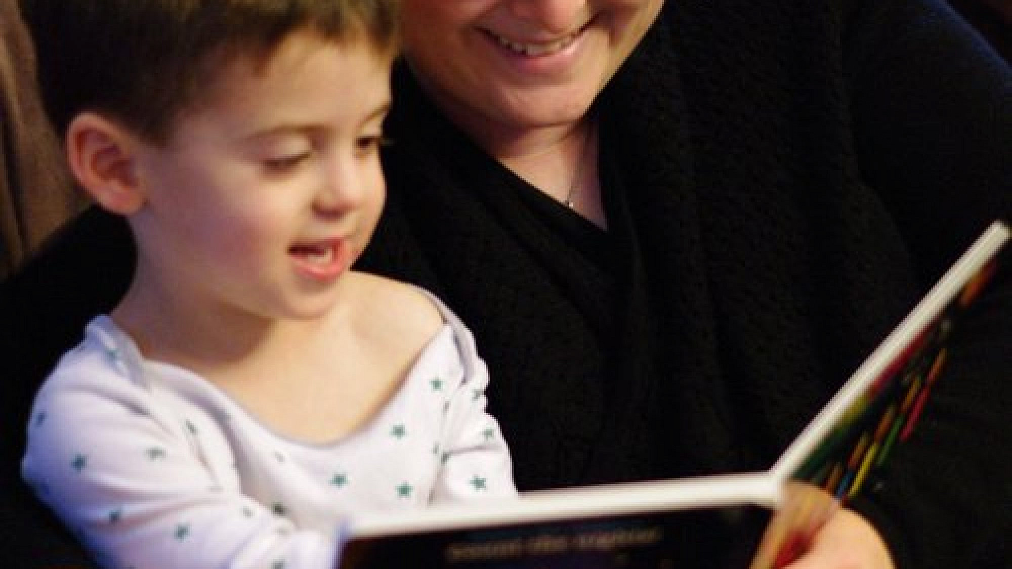 Joy Getnick reads a Hanukkah storybook to her son Benjamin. Credit: Jonathan Getnick.