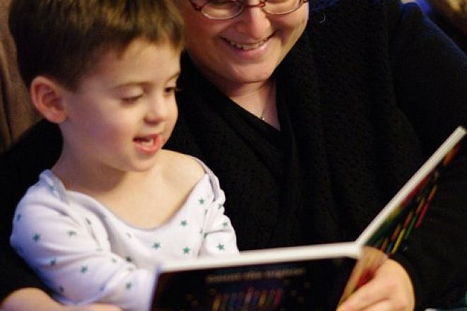 Joy Getnick reads a Hanukkah storybook to her son Benjamin. Credit: Jonathan Getnick.