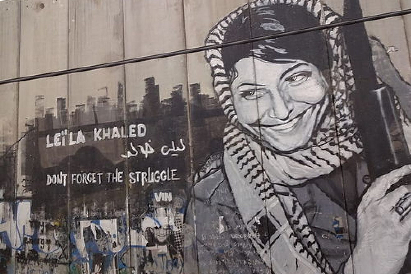 The Israeli security fence in Bethlehem is pictured here painted with graffiti depicting Popular Front for the Liberation of Palestine terrorist Leila Khaled. Rabab Abdulhadi, a professor at San Francisco State University, met with Khaled on a trip funded by the state of California. Credit: Bluewind via Wikimedia Commons.