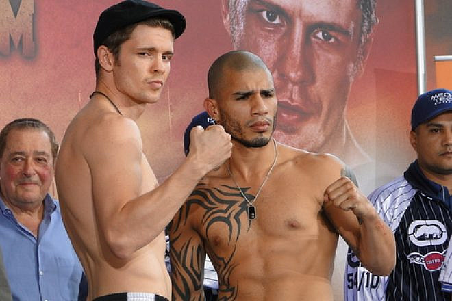 Yuri Foreman (left) and Miguel Cotto at their official weigh-in on June 4, 2010. Foreman would lose the fight, and his world championship, the next day. Credit: Chamber of Fear via Wikimedia Commons.