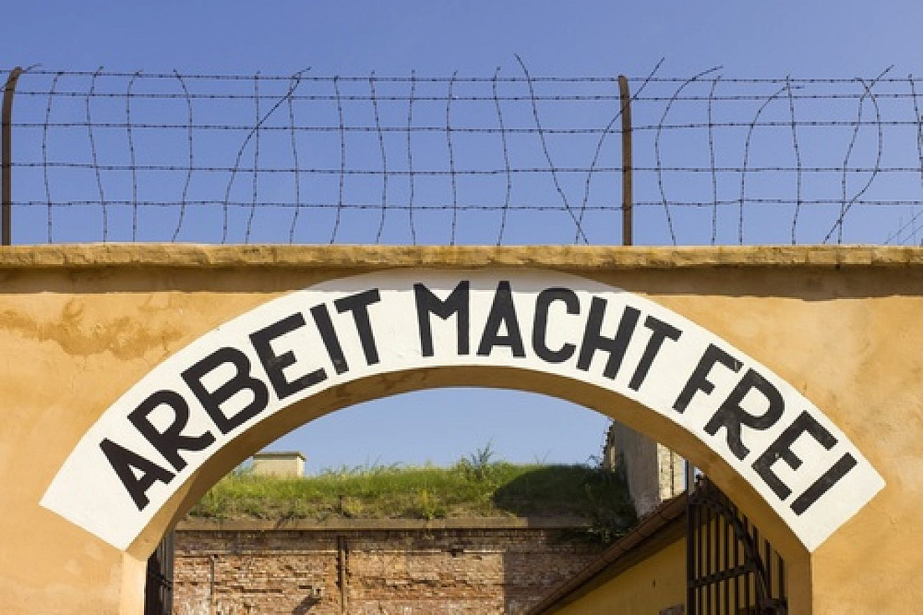 Theresienstadt concentration-camp archway with the phrase Arbeit Macht Frei, meaning "work makes (you) free," that was placed over the entrance in a number of Nazi concentration camps. Israeli Deputy Defense Minister Danny Danon wrote on International Holocaust Remembrance Day for JNS.org. Credit: Godot13 via Wikimedia Commons.