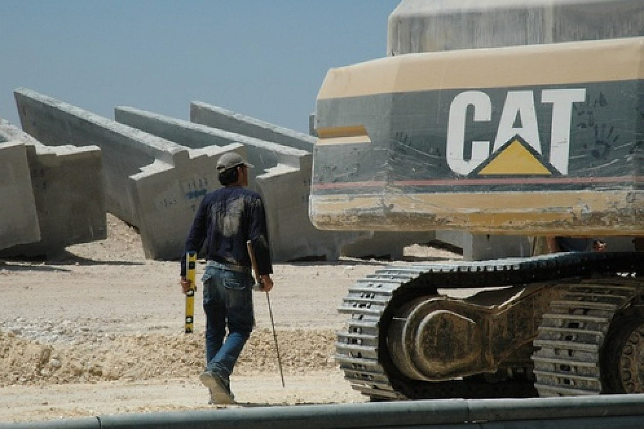 A Caterpillar bulldozer amid construction of the Israel's West Bank security fence. The Presbyterian Church (USA) General Assembly in July 2012 voted 333-331 against a resolution to divest from Caterpillar, Hewlett-Packard, and Motorola Solutions over those companies’ profit “from non-peaceful pursuits in Israel-Palestine.” Now, the Presbyterian Church's new study guide on the Arab-Israeli conflict has been accused of being a “hateful document” that “promotes the eradication of Israel.” Credit: Justin McIntosh via Wikimedia Commons.