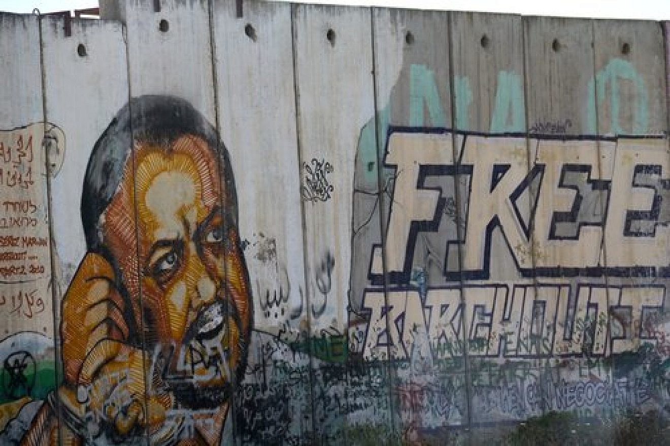 An image of Palestinian terrorist Marwan Barghouti, leader of the current hunger strike by Palestinian prisoners, painted on the security fence near the West Bank village of Qalandia. Credit: Haytham Shtayeh/Flash90.