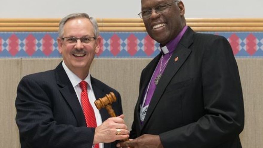 Click photo to download. Caption: The ceremonial passing of the gavel from outgoing United Methodist Church (UMC) Council of Bishops president Bishop Warner H. Brown, Jr. (at right) to the council's new president, Bishop Bruce R. Ought, during the UMC's quadrennial general conference in Portland, Ore., in May 2016. Credit: Mike DuBose/United Methodist News Service via Facebook.