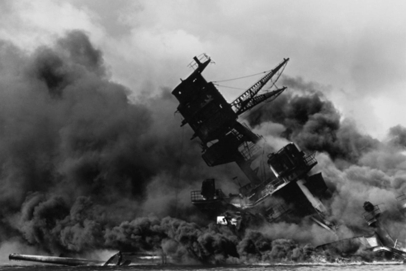 Click photo to download. Caption: In December 1941, the USS Arizona burns after being hit by a bomb in the Japanese attack on Pearl Harbor. Credit: National Archives and Records Administration via Wikimedia Commons.