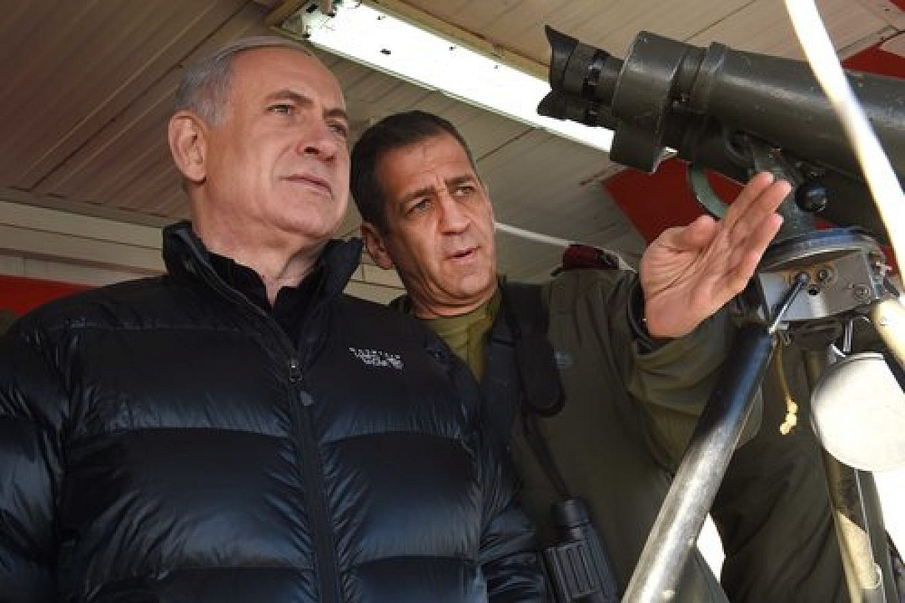 Israeli Prime Minister Benjamin Netanyahu (left) with Aviv Kochavi, head of the IDF Northern Command, during a visit to a military outpost on Mount Hermon in the Golan Heights, overlooking the Israel-Syria border, in February 2015. Credit: Effi Sharir/POOL/Flash90.