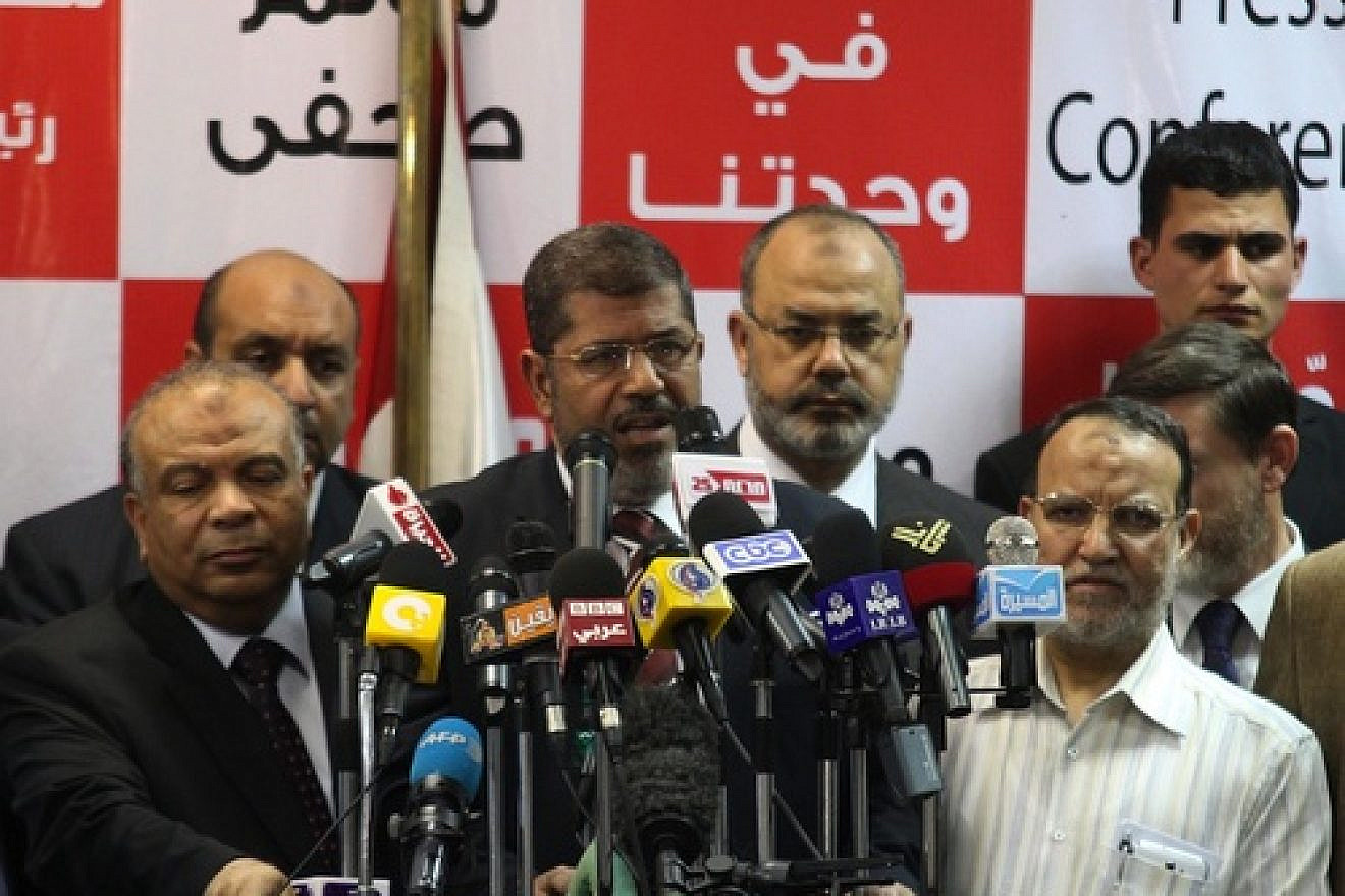 Egypt's Muslim Brotherhood presidential candidate Mohammed Morsi (center) speaks during a press conference in Cairo on June 18, 2012. The Muslim Brotherhood claimed victory in Egypt's first presidential election since Hosni Mubarak was ousted more than a year ago. Credit: EPA/AHMED KHALED.