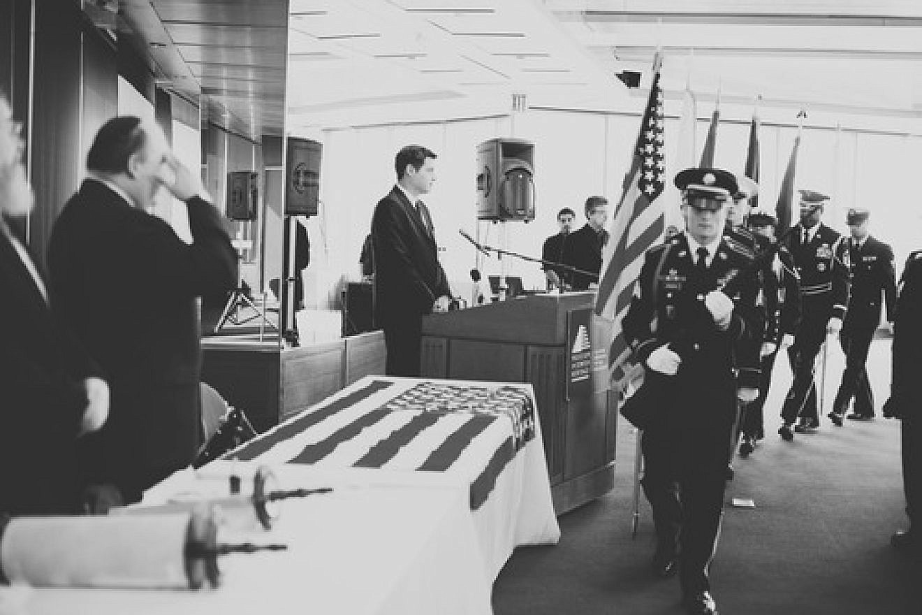 Click photo to download. Caption: The color guard marches during an Oct. 12 dedication of a Torah scroll for the U.S. military at the Museum of Jewish Heritage in Manhattan. At the podium is Jacob Kamaras, and at left giving a salute is his father, Philip Kamaras. Credit: Alexa Drew Photography.