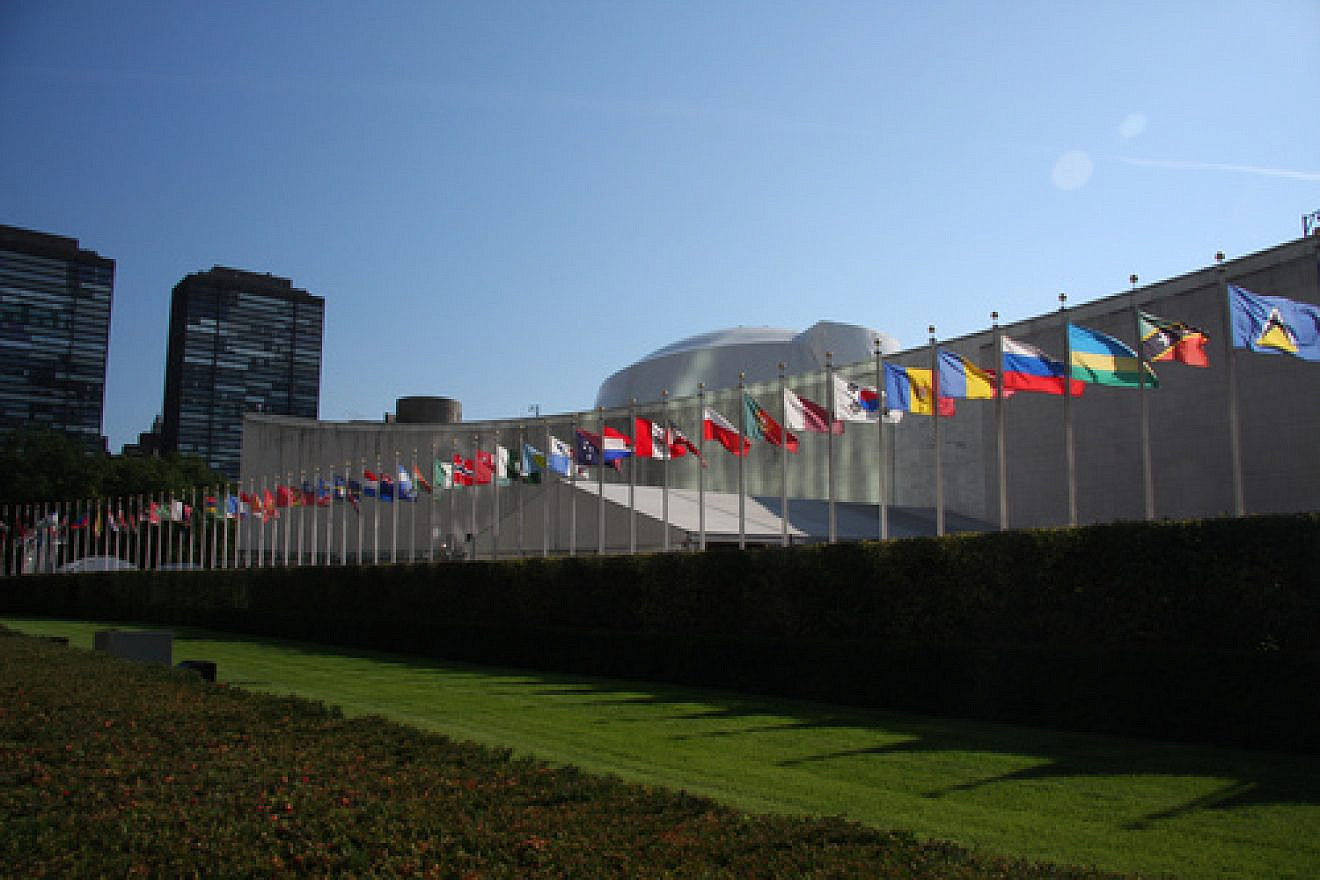 The row of flags of member countries of the United Nations in front of the U.N. General Assembly building in New York. Credit: Wikimedia Commons.