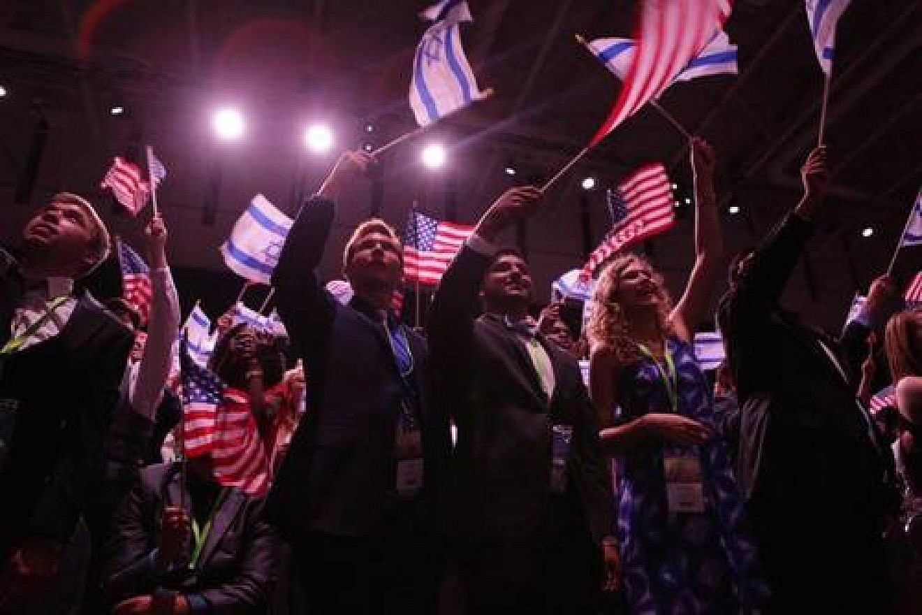 Attendees of the 10th Christians United for Israel (CUFI) Washington Summit wave Israeli and American flags, July 13, 2016. Credit: CUFI via Facebook.