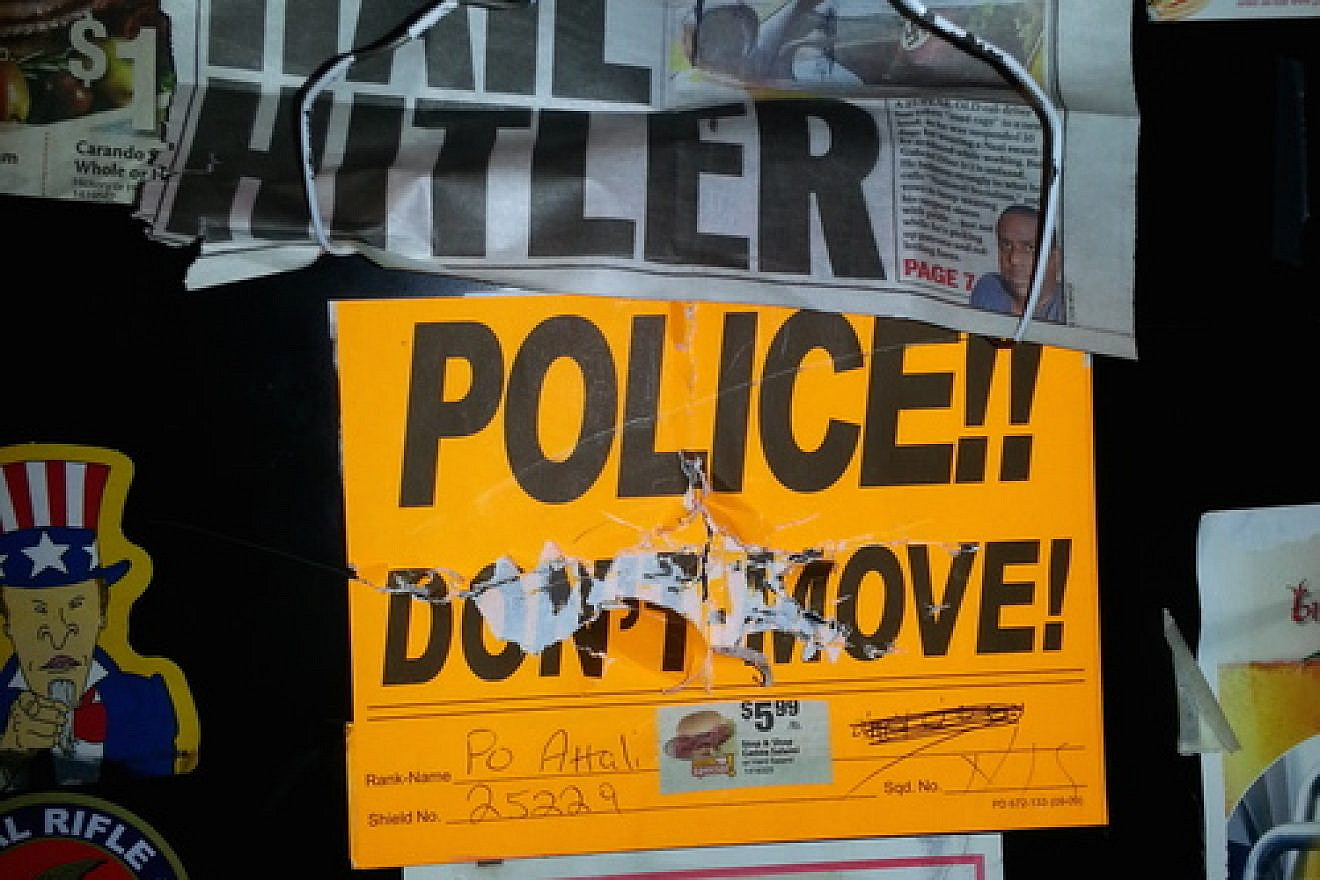 Anti-Semitic vandalism on the locker (pictured here) of former New York Police Department officer David Attali included swastikas, the words “dirty Jew,” pictures of ham or bacon (which are prohibited under Jewish dietary laws), and newspaper clippings that read: “Hail Hitler.” Credit: Courtesy.