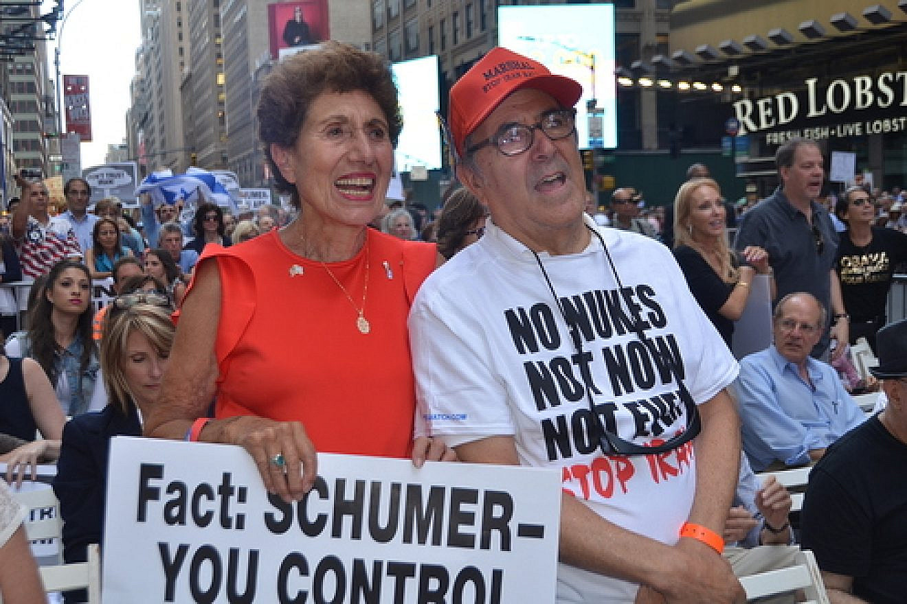 Pictured in front, Helen Freedman, director of Americans for a Safe Israel, with Charles Bernhardt at a July 22 rally against the Iran deal in New York City. The sign held by Freedman targets the vote of U.S. Sen. Chuck Schumer (D-N.Y.), who later announced he would oppose the deal. But the Senate will fall short of producing the 67 anti-deal votes needed to override a presidential veto of its collective decision. Credit: Maxine Dovere.