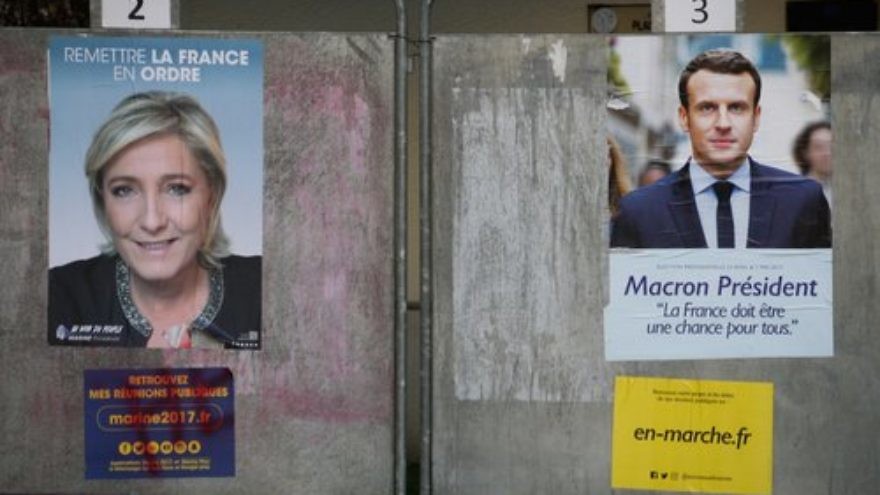 Posters showing French presidential candidates Marine Le Pen (left) and Emmanuel Macron outside a polling station in Cesson, France, April 23. Credit: Marion Sindel/Flash90.