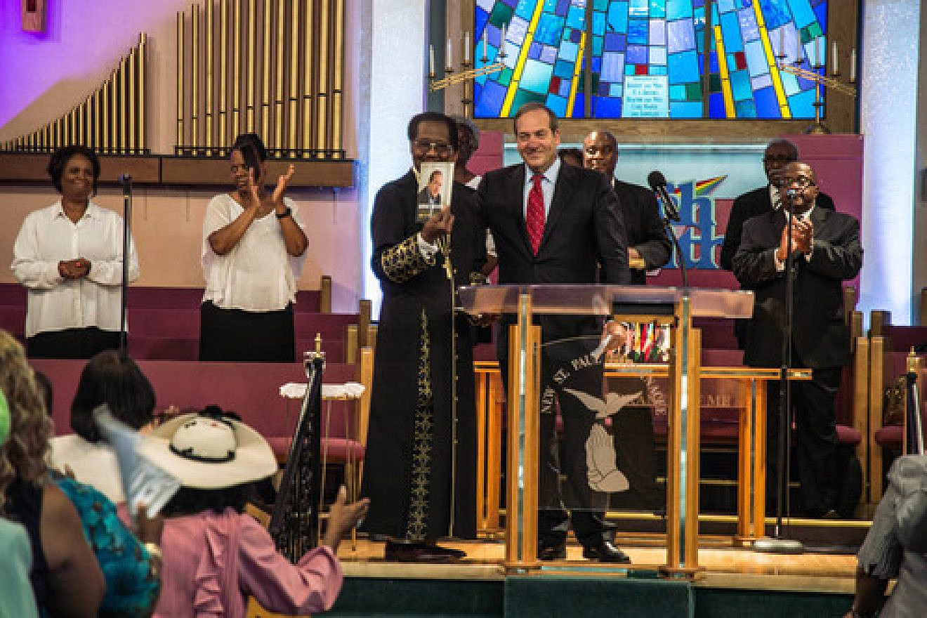In August 2015 in Detroit, Rabbi Yechiel Eckstein (center right, at podium), founder and president of the International Fellowship of Christians and Jews, visits the New St. Paul Tabernacle Church of God in Christ, which is part of the nation's largest black Pentecostal denomination. Credit: Justin McMahan.