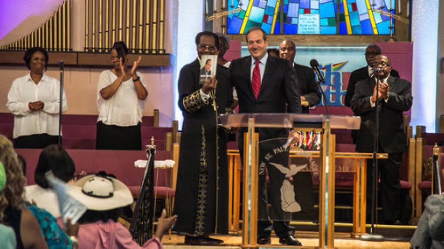 In August 2015 in Detroit, Rabbi Yechiel Eckstein (center right, at podium), founder and president of the International Fellowship of Christians and Jews, visits the New St. Paul Tabernacle Church of God in Christ, which is part of the nation's largest black Pentecostal denomination. Credit: Justin McMahan.