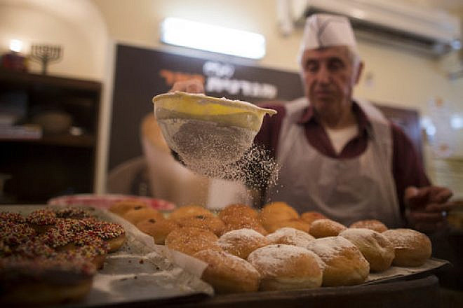 Sufganiyot (deep-fried doughnuts) are made at the Jerusalem-based Magdinat Pe’er bakery Nov. 26, 2012, leading up to Hanukkah. Credit: Yonatan Sindel/Flash90.
