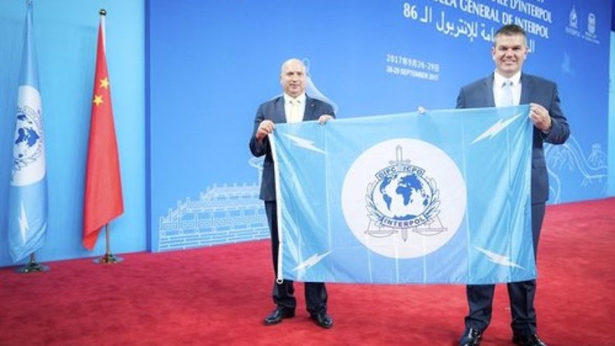 The Palestinians accept their Interpol flag at the international police organization's General Assembly in Beijing. Credit: Interpol.