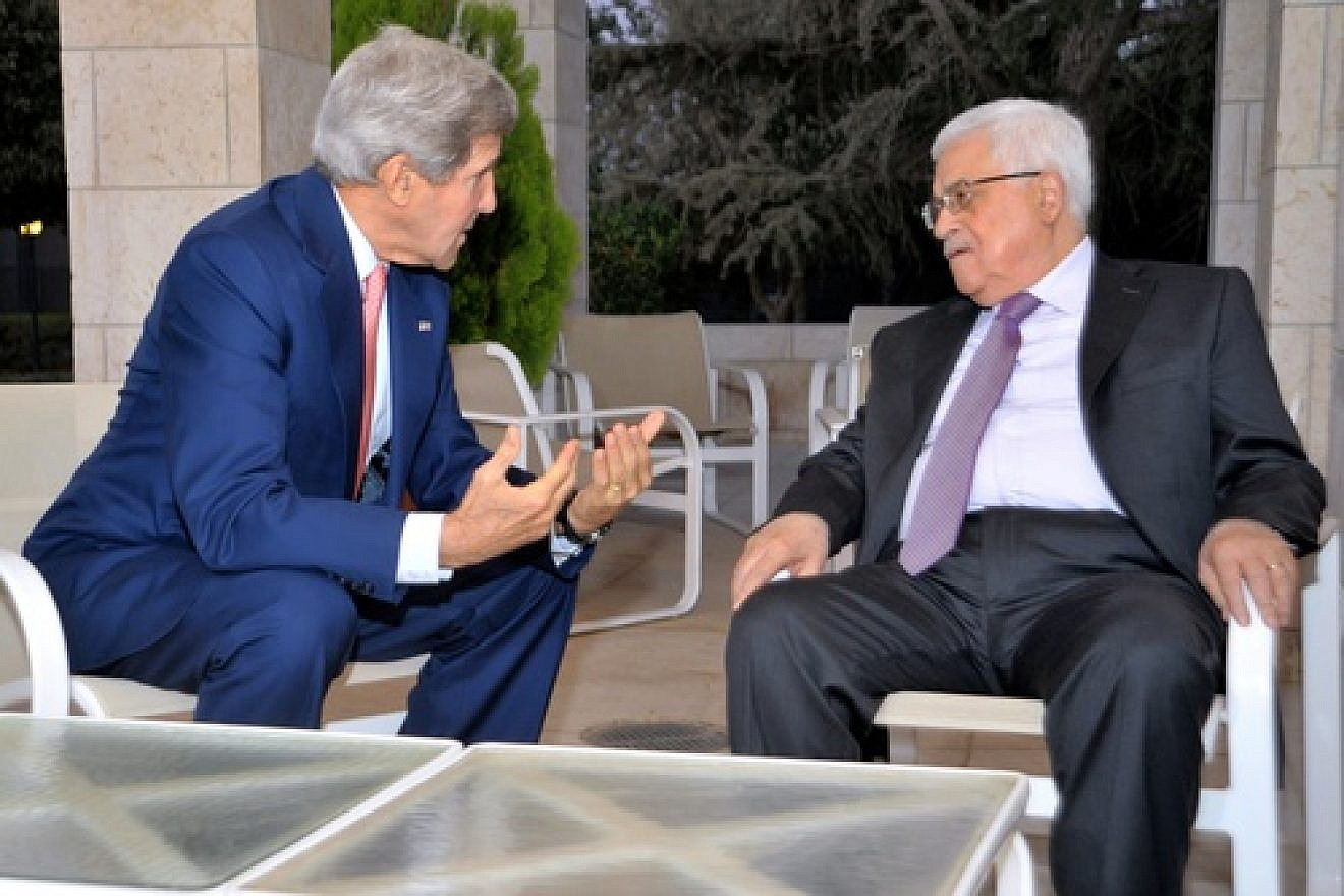 U.S. Secretary of State John Kerry sits with Palestinian Authority leader Mahmoud Abbas before they meet and celebrate Iftar, the breaking of the daily fast during the Islamic holy month of Ramadan, in Amman, on July 16, 2013. Credit: U.S. State Department.