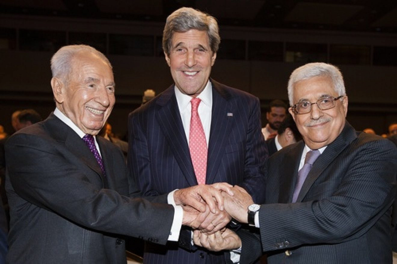 From left to right: Israeli President Shimon Peres, U.S. Secretary of State John Kerry, and Palestinian Authority leader Mahmoud Abbas shake hands at the World Economic Forum on the Middle East and North Africa in Amman, Jordan, on May 26, 2013. Kerry on Friday announced an agreement on a "basis" for renewed Israeli-Palestinian conflict talks. Photo by Flash90.
