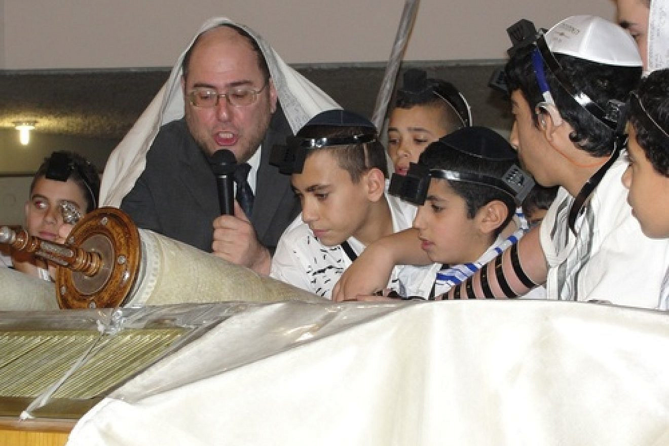 Rabbi Chanoch Yeres, director of the Deaf Programming Division of International Young Israel Movement (IYIM), leads a 2013 bar mitzvah for 63 deaf and hard-of-hearing children. Credit: Judy Lash Balint.