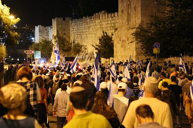 Thousands of Jews march in a demonstration around the walls of Jerusalem’s Old City, calling on the Israeli government to allow Jewish prayer at the Temple Mount, on the eve of the Tisha B’Av day of Jewish mourning, July 31, 2017. Photo by Gershon Elinson/Flash90.