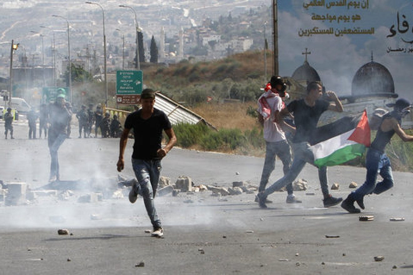 Palestinians hurl stones at Israeli security forces during a demonstration at the Huwara checkpoint, near Nablus, amid Muslim riots over Jerusalem’s Temple Mount holy site July 21, 2017. Photo by Nasser Ishtayeh/Flash90