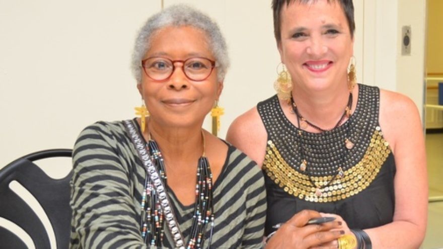Click photo to download. Caption: Author Alice Walker and playwright Eve Ensler clasp hands at the 92nd Street Y in New York City on the night they appeared together in dialogue, May 30. Credit: Maxine Dovere.