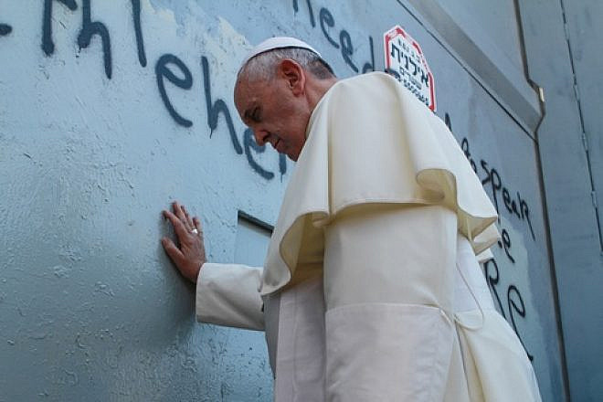 Pope Francis touches the Israeli security barrier on his way to lead a mass in Bethlehem, on May 25, 2014. Credit: Nour Shamaly/POOL/Flash90.