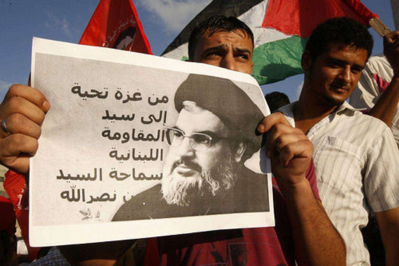 A Palestinian protester from the Popular Front for the Liberation of Palestine (PFLP) holds a picture Hezbollah leader Sheikh Hassan Nasrallah during a demonstration in Rafah, in the southern Gaza Strip, on Sept. 3, 2014. Credit: Abed Rahim Khatib/Flash90.