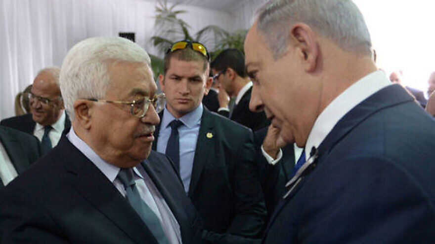 Israeli Prime Minister Benjamin Netanyahu meets with Palestinian Authority leader Mahmoud Abbas during the funeral of late Israeli President Shimon Peres, held at Mount Herzl in Jerusalem on Sept. 30, 2016. Credit: Amos Ben Gershom/GPO.