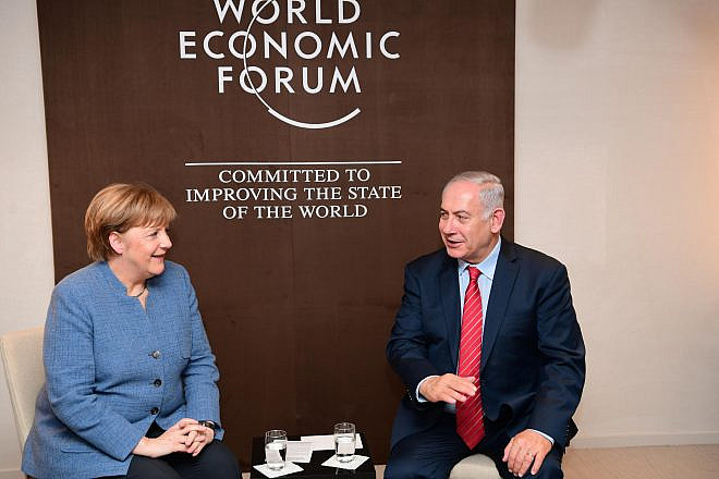 Israeli Prime Minister Benjamin Netanyahu and German Chancellor Angela Merkel meet at the World Economic Forum in Davos. Credit: Amos Ben-Gershom/GPO.