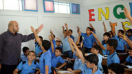 Palestinian boys raise their hands at a school in Gaza supported by the United Nations Relief and Works Agency for Palestine Refugees in the Near East (UNRWA) in September 2011. Credit: U.N. Photo/Shareef Sarhan.