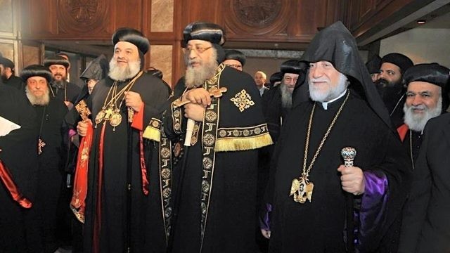In July 2016, Pope Tawadros II of Alexandria (pictured in front at center)—the leader of Egypt’s Coptic Orthodox Church—hosts Ignatius Aphrem II (left), patriarch of Antioch and All East of the Syriac Orthodox Church, and Aram I, head of Lebanon’s Catholicosate of the Great House of Cilicia of the Armenian Apostolic Church. Credit: Wikimedia Commons.
