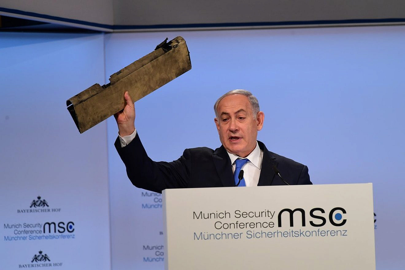 Prime Minister Benjamin Netanyahu displays a fragment of an Iranian drone destroyed over Israeli airspace in February 2018 during his speech at the Munich Security Conference. Credit: GPO.