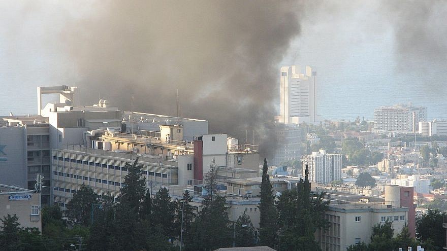Smoke rises over Haifa after a rocket fired by Hezbollah hit near the Bnai Zion Medical Center during the 2006 Second Lebanon War. Credit: Wikimedia Commons.