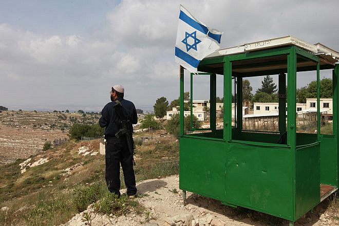 An Israeli security guard at his post at the Bat Ain settlement in Gush Etzion. Credit: Nati Shohat/Flash90.