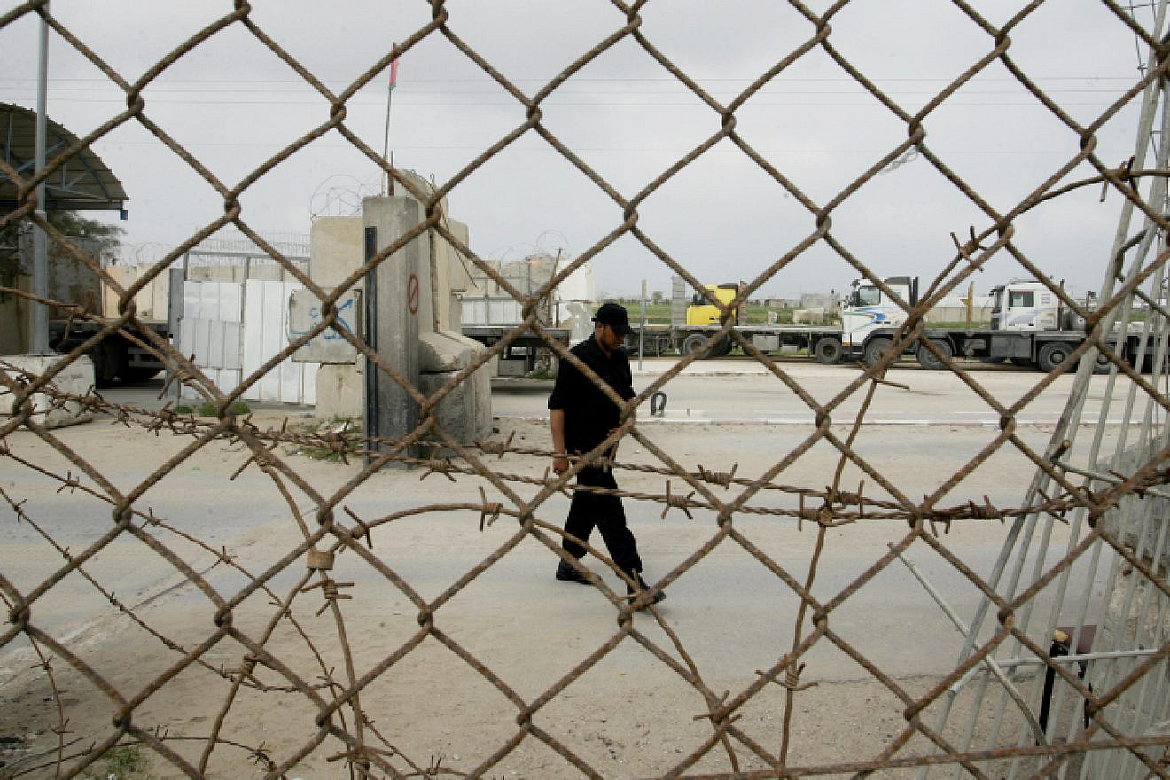 A member of the Hamas security forces stand guard at the Kerem Shalom crossing between Israel and the southern Gaza Strip on Feb. 24, 2014. Photo Abed Rahim Khatib/Flash90.