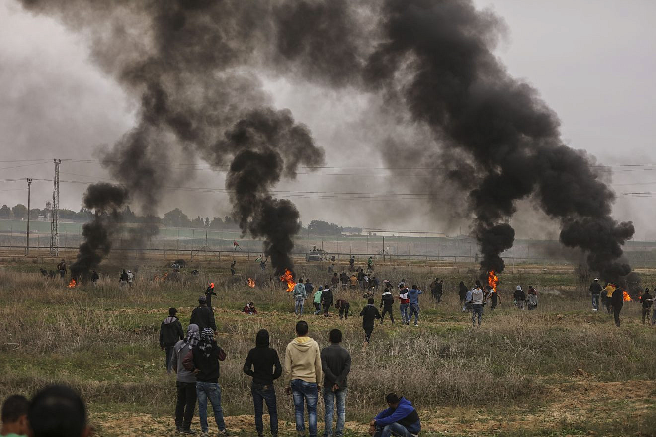 Palestinian protesters clash with Israeli soldiers near the border fence east of Gaza City on Dec. 22, 2017. Credit: Wissam Nassar/Flash90.