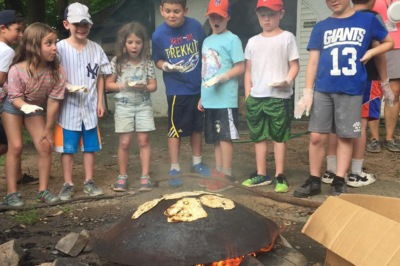 Campers making pita on their outdoor oven with recipes received through their Israel @ Camp Resource Box.  Credit: iCenter for Jewish Education.