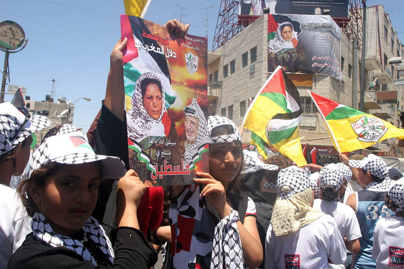 Palestinians hold posters showing Dalal Mughrabi, a terrorist involved in an infamous 1978 attack in which 35 Israelis were killed. Photo by Issam Rimawi/Flash 90.
